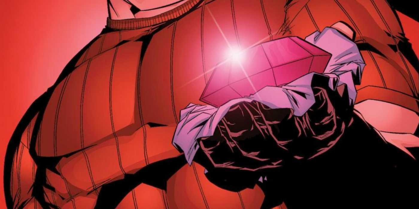 Close-up of a hand holding the glowing Crimson Gem